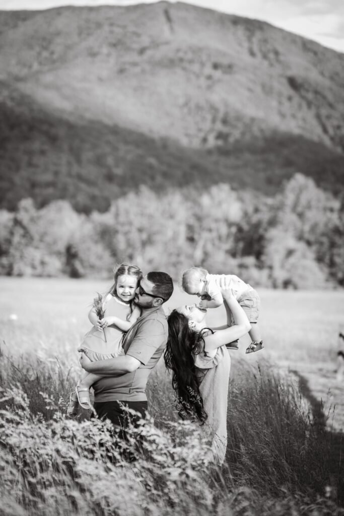 Family smiling together during an outdoor portrait session in Gatlinburg, TN.